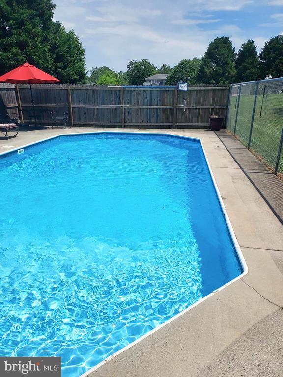 view of swimming pool featuring a patio area, fence, and a fenced in pool