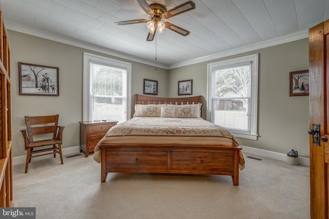 bedroom with visible vents, multiple windows, light colored carpet, and crown molding