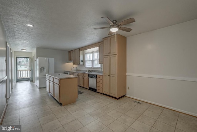 kitchen with visible vents, a kitchen island, dishwasher, light countertops, and white fridge with ice dispenser