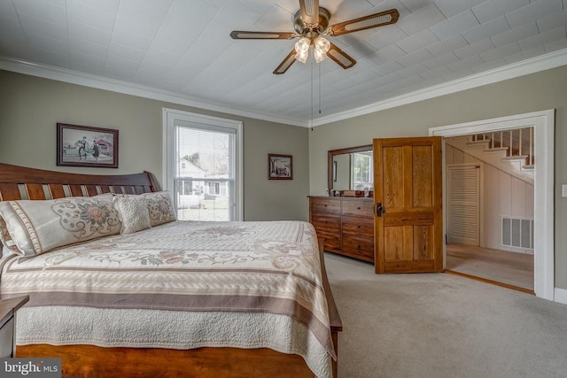 bedroom featuring light carpet, visible vents, crown molding, and ceiling fan