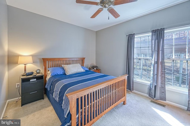 bedroom with multiple windows, carpet flooring, visible vents, and baseboards