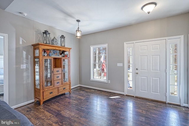 foyer featuring baseboards, visible vents, and hardwood / wood-style floors