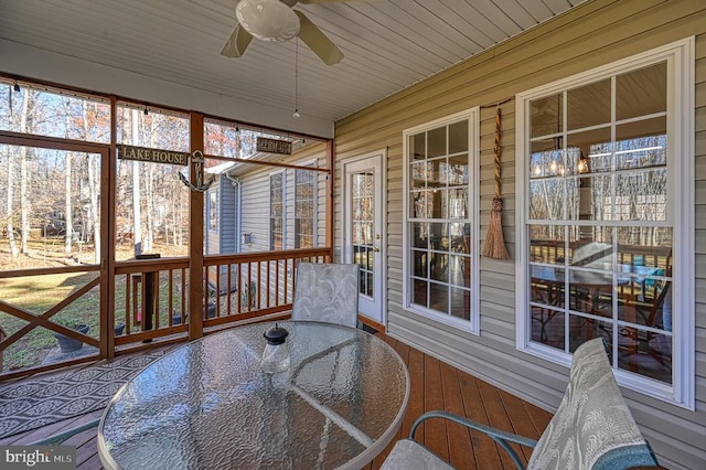 sunroom / solarium with a ceiling fan