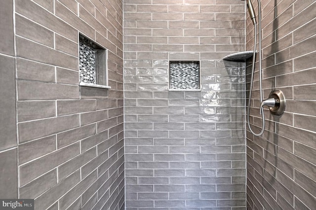 bathroom with tiled shower