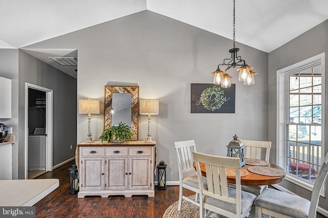 dining area with dark wood finished floors, washer / clothes dryer, vaulted ceiling, and baseboards