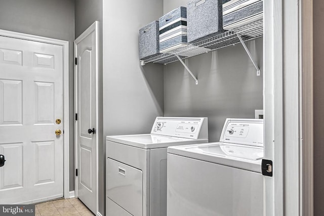 laundry area featuring light tile patterned floors, laundry area, and independent washer and dryer