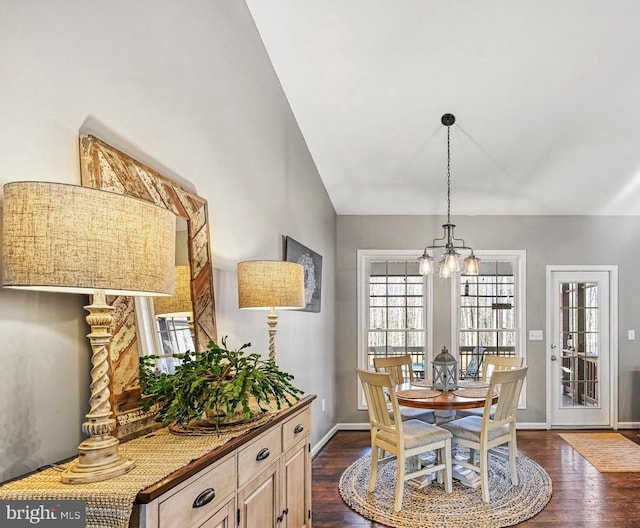 dining room featuring lofted ceiling, baseboards, a chandelier, and dark wood-type flooring