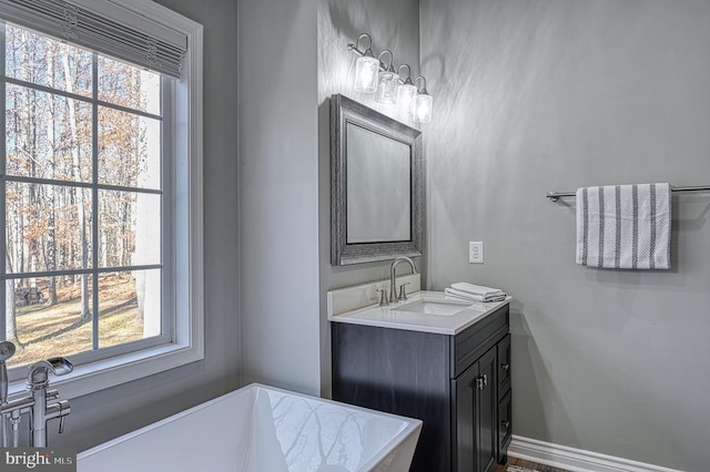 bathroom with vanity and baseboards