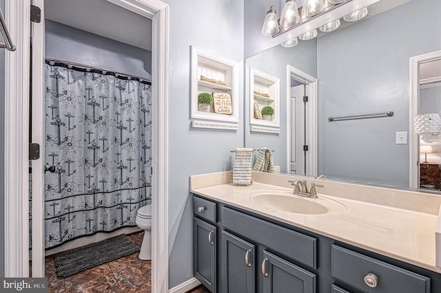 bathroom featuring a shower with curtain, vanity, and toilet