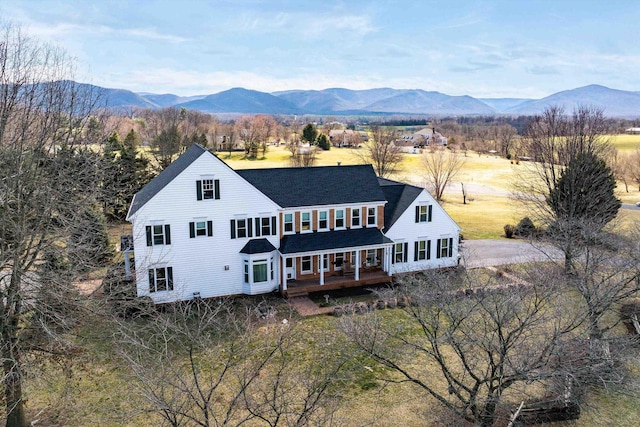 exterior space with a deck with mountain view