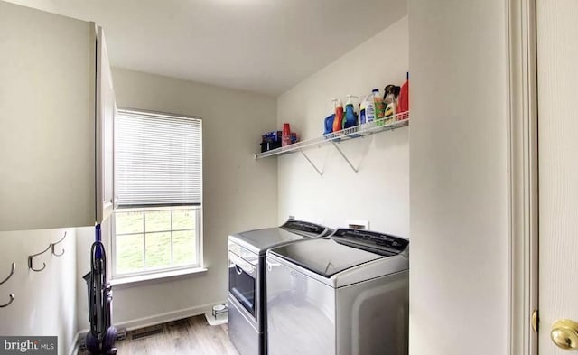 laundry area featuring visible vents, baseboards, washing machine and dryer, laundry area, and light wood-style floors