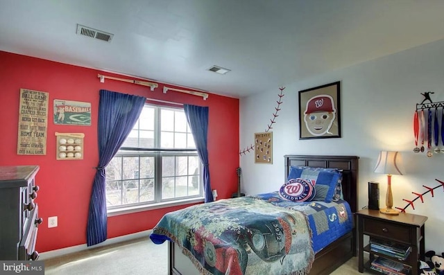 carpeted bedroom with visible vents and baseboards