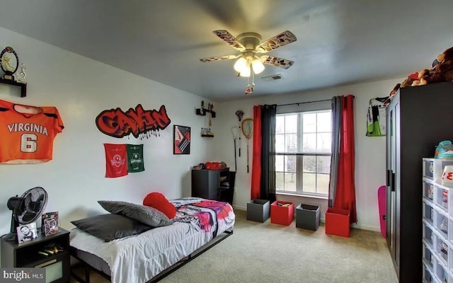 carpeted bedroom featuring visible vents, baseboards, and ceiling fan