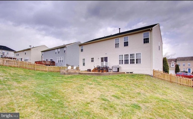 back of house featuring a yard and fence