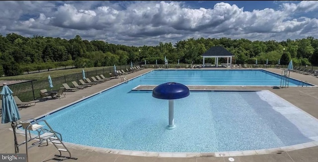 pool featuring a gazebo, a patio area, and fence