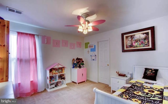 bedroom featuring baseboards, light colored carpet, visible vents, and ceiling fan