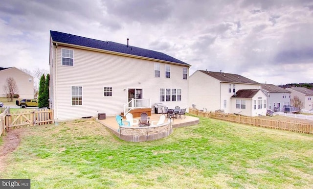 back of house with a yard, a patio, a fenced backyard, and an outdoor fire pit