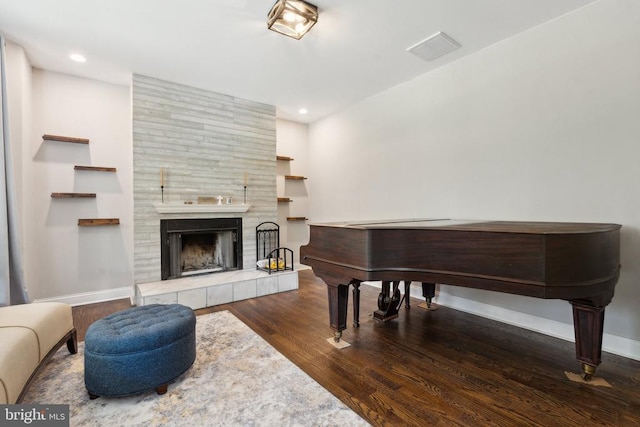 misc room featuring dark hardwood / wood-style flooring and a fireplace