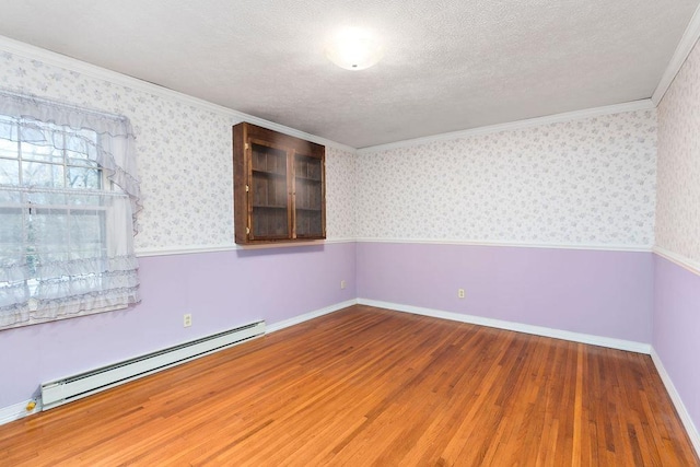 unfurnished room featuring wainscoting, a baseboard radiator, and wallpapered walls