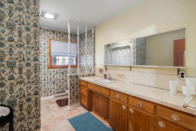 bathroom with a baseboard radiator, vanity, and tile patterned floors