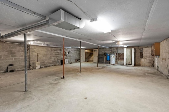 unfinished basement with concrete block wall and strapped water heater