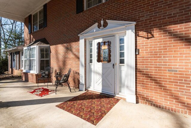 property entrance with brick siding