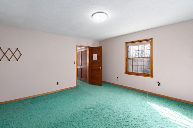 empty room with carpet floors and baseboards