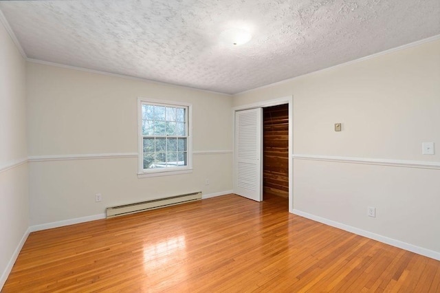 unfurnished bedroom featuring a textured ceiling, a closet, a baseboard radiator, and light wood-style floors