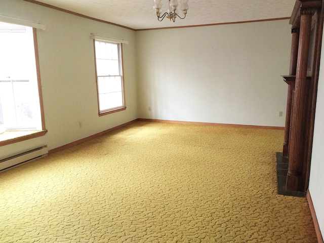 spare room featuring baseboards, ornamental molding, and an inviting chandelier