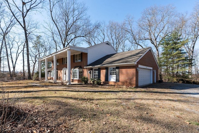 neoclassical / greek revival house with covered porch, driveway, brick siding, and an attached garage