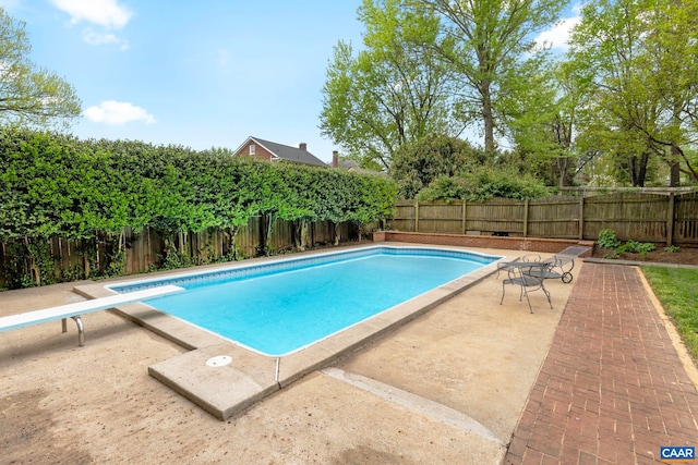 view of swimming pool with a fenced backyard, a fenced in pool, and a patio