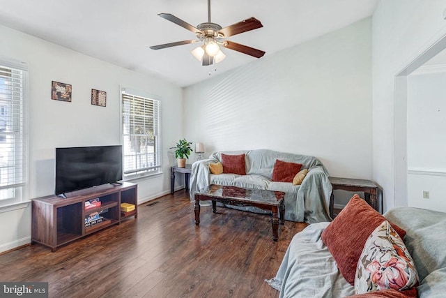 living area with baseboards, a ceiling fan, and wood finished floors