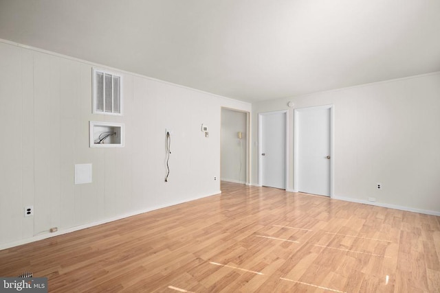 unfurnished room with light wood-type flooring