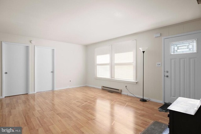 entryway with a baseboard radiator and light hardwood / wood-style floors