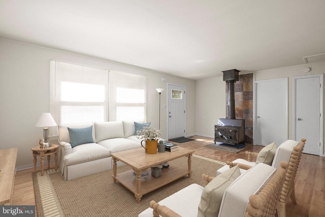 living room featuring light hardwood / wood-style flooring and a wood stove