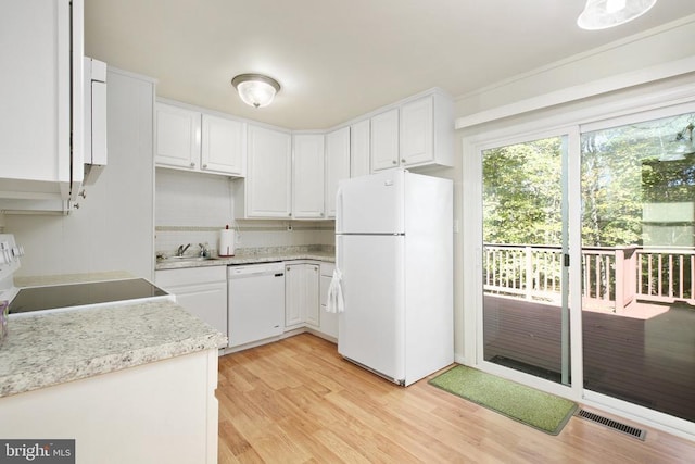 kitchen featuring white cabinetry, sink, white appliances, and light hardwood / wood-style flooring