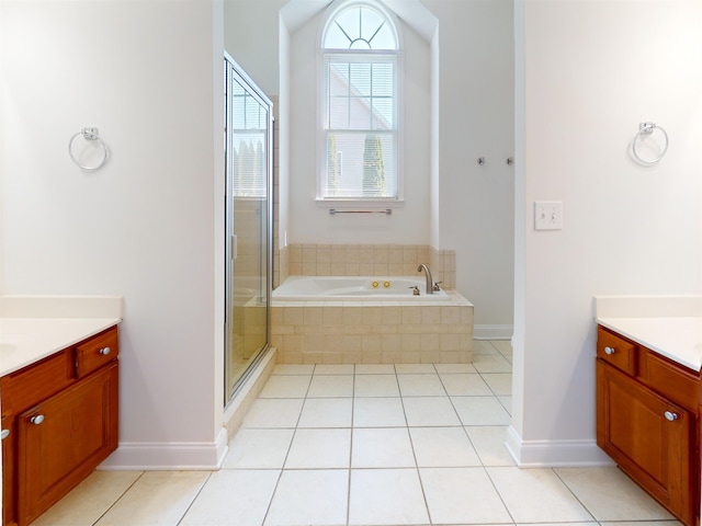 full bath featuring vanity, baseboards, a bath, tile patterned floors, and a stall shower