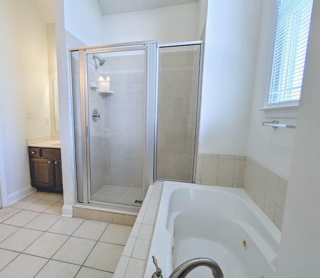 bathroom with a whirlpool tub, tile patterned floors, a shower stall, and vanity