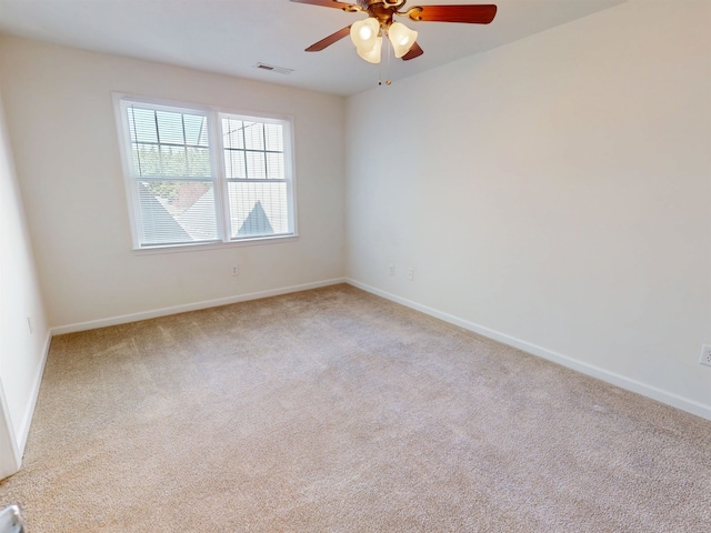 carpeted spare room featuring a ceiling fan, baseboards, and visible vents