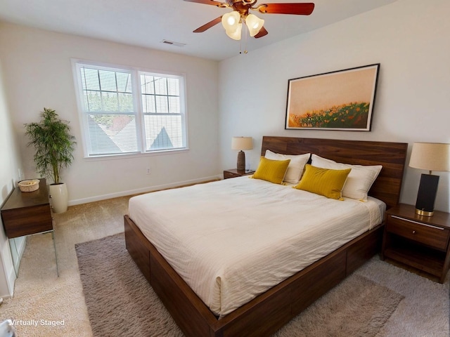 bedroom featuring a ceiling fan, baseboards, visible vents, and light carpet