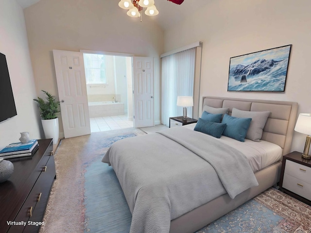 bedroom with high vaulted ceiling, ensuite bathroom, and carpet flooring
