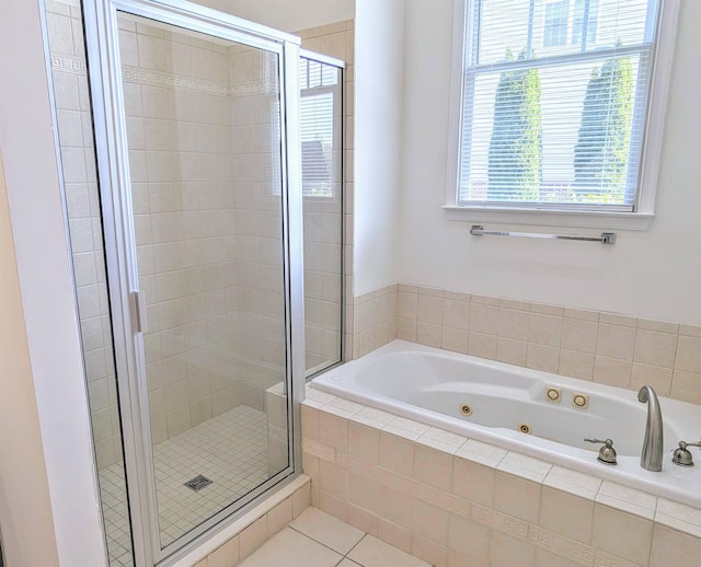 full bath featuring a shower stall, tile patterned flooring, and a jetted tub