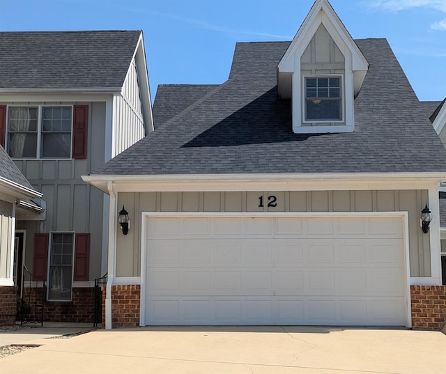 exterior space with brick siding, a shingled roof, board and batten siding, and driveway