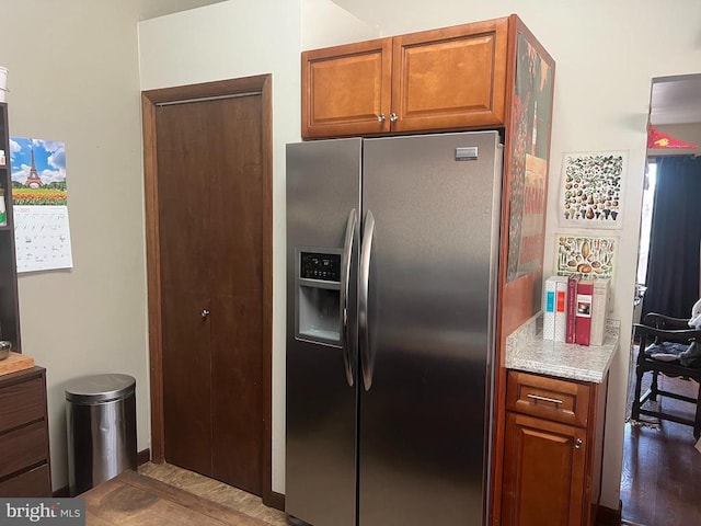 kitchen with brown cabinets and stainless steel fridge with ice dispenser