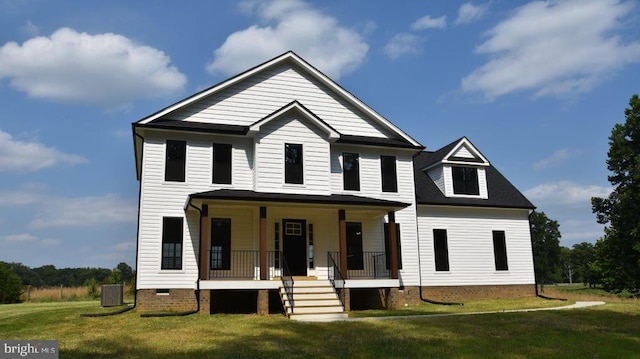 view of front facade with a front yard and covered porch