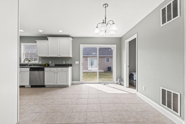 kitchen featuring dark countertops, white cabinetry, visible vents, and dishwasher