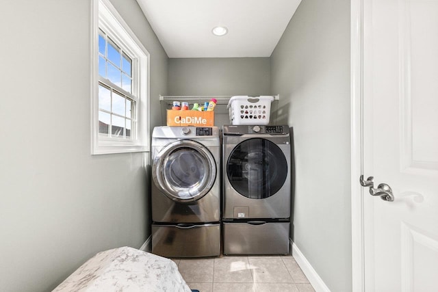 laundry room with baseboards, laundry area, independent washer and dryer, and tile patterned floors