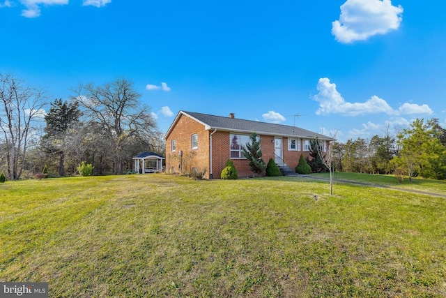 view of front of house with brick siding and a front lawn