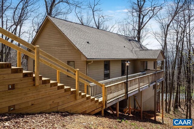 back of property with a wooden deck