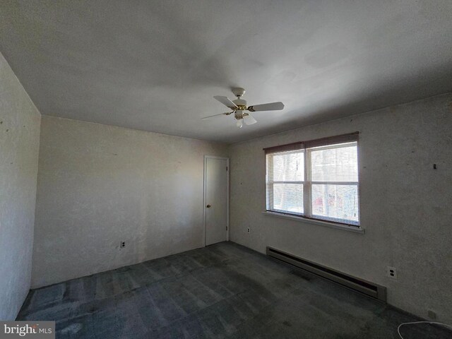 empty room featuring a baseboard heating unit and ceiling fan